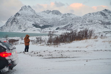 Muslim traveler praying in cold snowy winter day