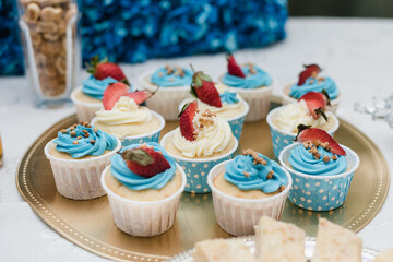 cupcakes on a tray, cupcakes with cream, muffins with berries