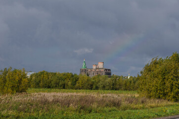 Fototapeta na wymiar September, 2020 - Kholmogory. Rainbow over the ancient Transfiguration Cathedral. Russia, Arkhangelsk region
