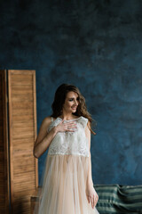 Portrait of a beautiful young female in a white underwear. Morning of the bride.
