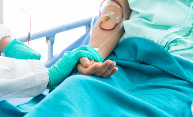 Fototapeta premium Doctor checking pulse and heart rate on patient wrist in the hospital.