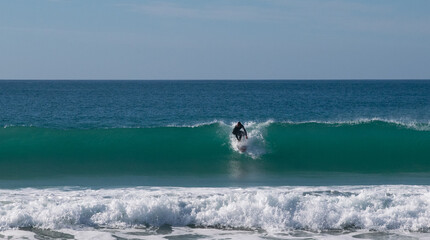 Young surfer riding perfect surf wave at the beach of El Palmar. Spanish Atlantic coast in Cadiz,...