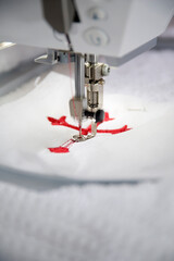 Red cross embroidery with sewing machine close-up