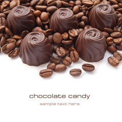 Chocolate candies with coffee beans over white background