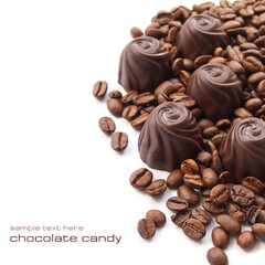 Chocolate candies with coffee beans over white background