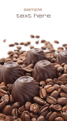 Chocolate candies with coffee beans over white background