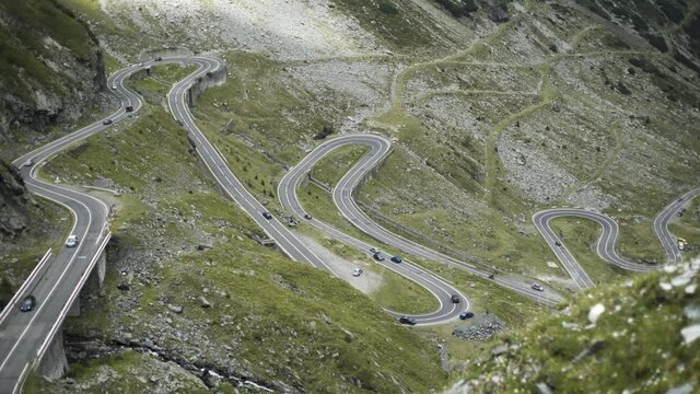 Romania - Fagaras Mountains in Transylvania. Famous Transfagarasan mountain winding road with cars.