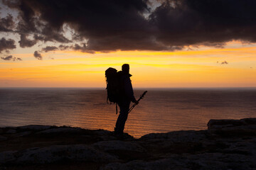 Trekking near the sea at the sunset