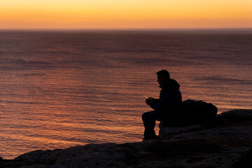 Man with smartphone at the sunset