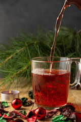 Close-up of rooibos tea cup with christmas decoration on wooden table, vertical