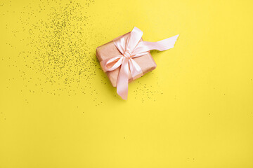 New Year's gift and yellow background with Illuminating sequins