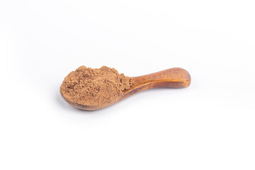 Studio lighting. allspice on a wooden spoon, on a white background. There is a shadow. Close-up. No isolation.