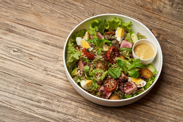 Quinoa salad with boiled egg and fresh vegetables