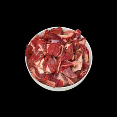 Full bowl of fresh raw meat isolated on black background. Top view.