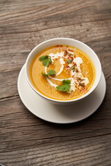 Pumpkin soup on a wooden table. Pumpkin soup puree