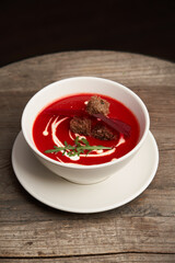 Beetroot soup on a wooden table. Beetroot soup puree