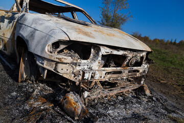 Burned down car, abstract background, selective focus. The situation of protests in the world.