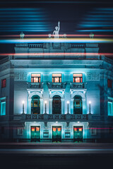 Facade of the Yekaterinburg Opera and Ballet Theater at night with light trails of passing cars