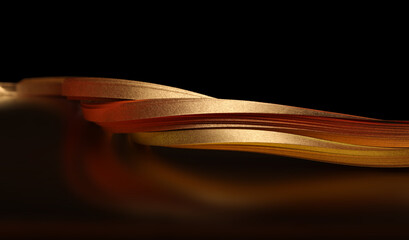Gold (bronze) paper wave on black. Soft focus Abstract backgound.