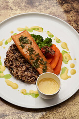 Salmon fillet and rice on white plate. Baked salmon with rice
