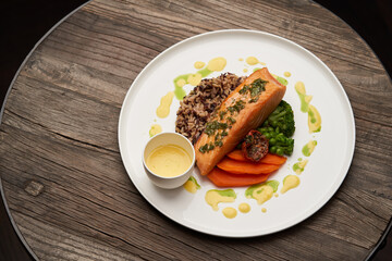 Salmon fillet and rice on white plate. Baked salmon with rice