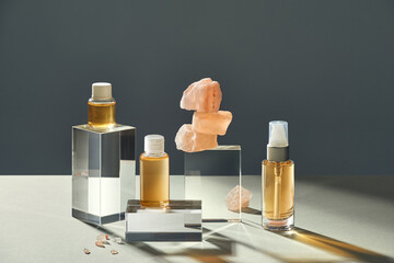 Cosmetic oil in glass vial and stacked rock salt pink Himalaya
