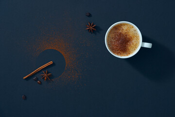 Coffee mug with cinnamon and beans