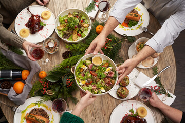 Christmas table with food, top view. Friends having dinner