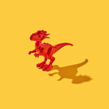 Plastic model of dinosaur with shadows.