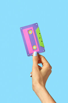 Hand holds handmade paper cassette.