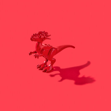 Plastic model of dinosaur with shadows.