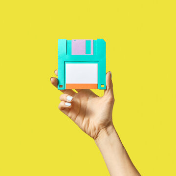 Handmade paper floppy disk in a hand.