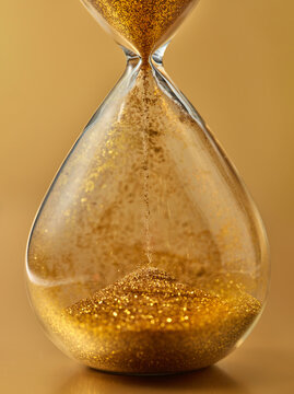 Close-up of pouring golden sand.