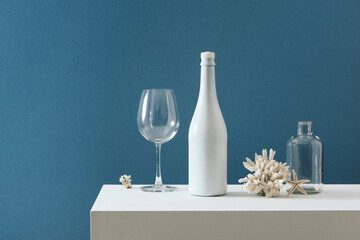 A white bottle of wedding champagne and a luxurious on a banquette table