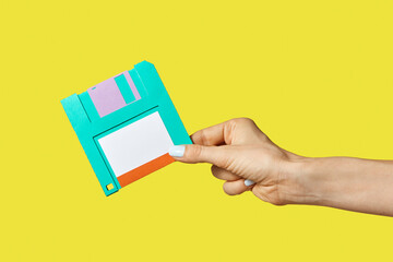 Paper craft diskette in the hand.