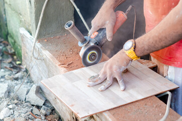 dark Latino man using a machine to cut pottery. construction work machine on a cut ceramic