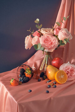 Sunny still life with garden flowers and fruits. bouquet in a vase