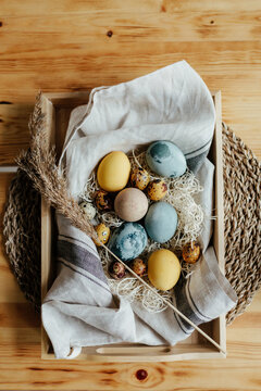 Container with creatively decorated colorful Easter eggs