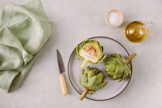 Raw Artichokes with Salt and Olive Oil Horizontal Overhead Shot