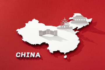 China map cutted from paper with nationals symbol. Travel concept.