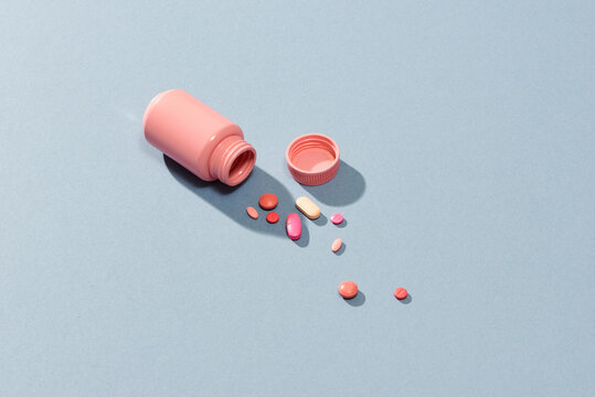 Pink medicine box and colorful pills