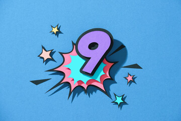 Paper cut with number 9 on speech bubble.