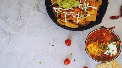 Skillet Turkey Chili Nachos topped with sourcream and guacamole