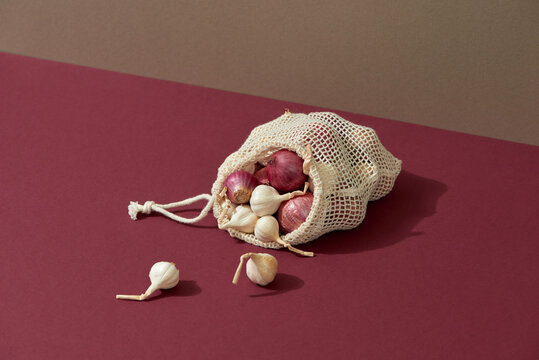 The reusable organza net bag for shopping with onion and garlic.