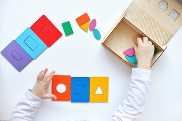 Learning colors and shapes. Children's wooden toy. The child collects a sorter. Educational logic toys for kid's. Kindergarten educational toys, Cognitive skills, Learn Through Play tools concept