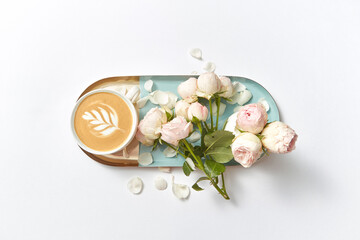 Ceramic tray with cappuccino and flowers.