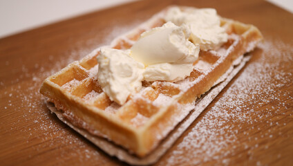 Belgian Waffle with sugar and cream - close up shot