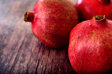 Full pomegranate on a wooden table