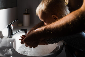 Father washing Childs hands