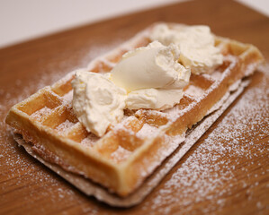Belgian Waffle with sugar and cream - close up shot
